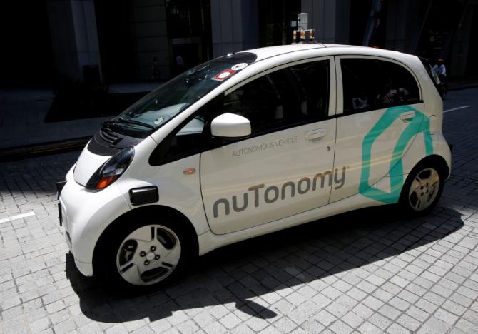 A nuTonomy self-driving taxi drives on the road in its public trial in Singapore